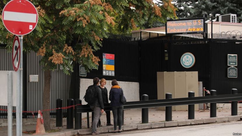 (1/2)FILE - People are seen in front of the visa application office entrance of the U.S. Embassy in Ankara, Turkey, Oct. 9, 2017. The U.S. suspended all non-immigrant visa services in Turkey Oct 8. and has since resumed only limited services.