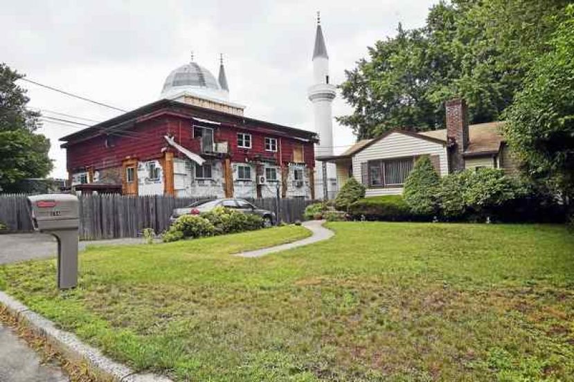 The 81-foot fiberglass minarets flank the 12,000-square-foot mosque’s exterior, photographed from Weybosset Street in New Haven. Catherine Avalone / Hearst Connecticut Media